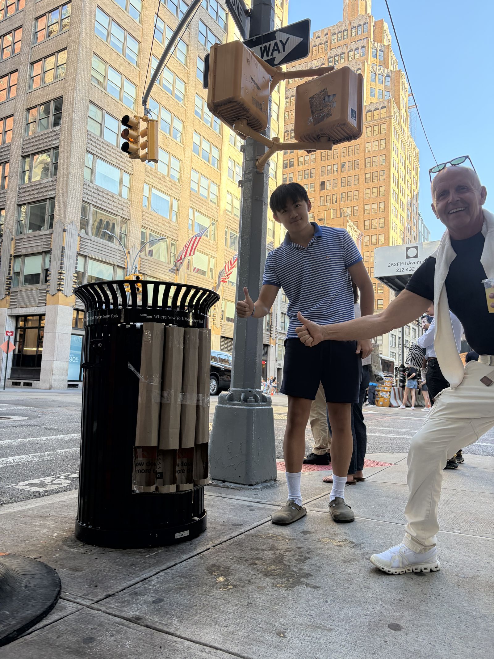 Edin Cheng and a passer-by giving a thumbs up beside the installed rack on a Manhattan corner