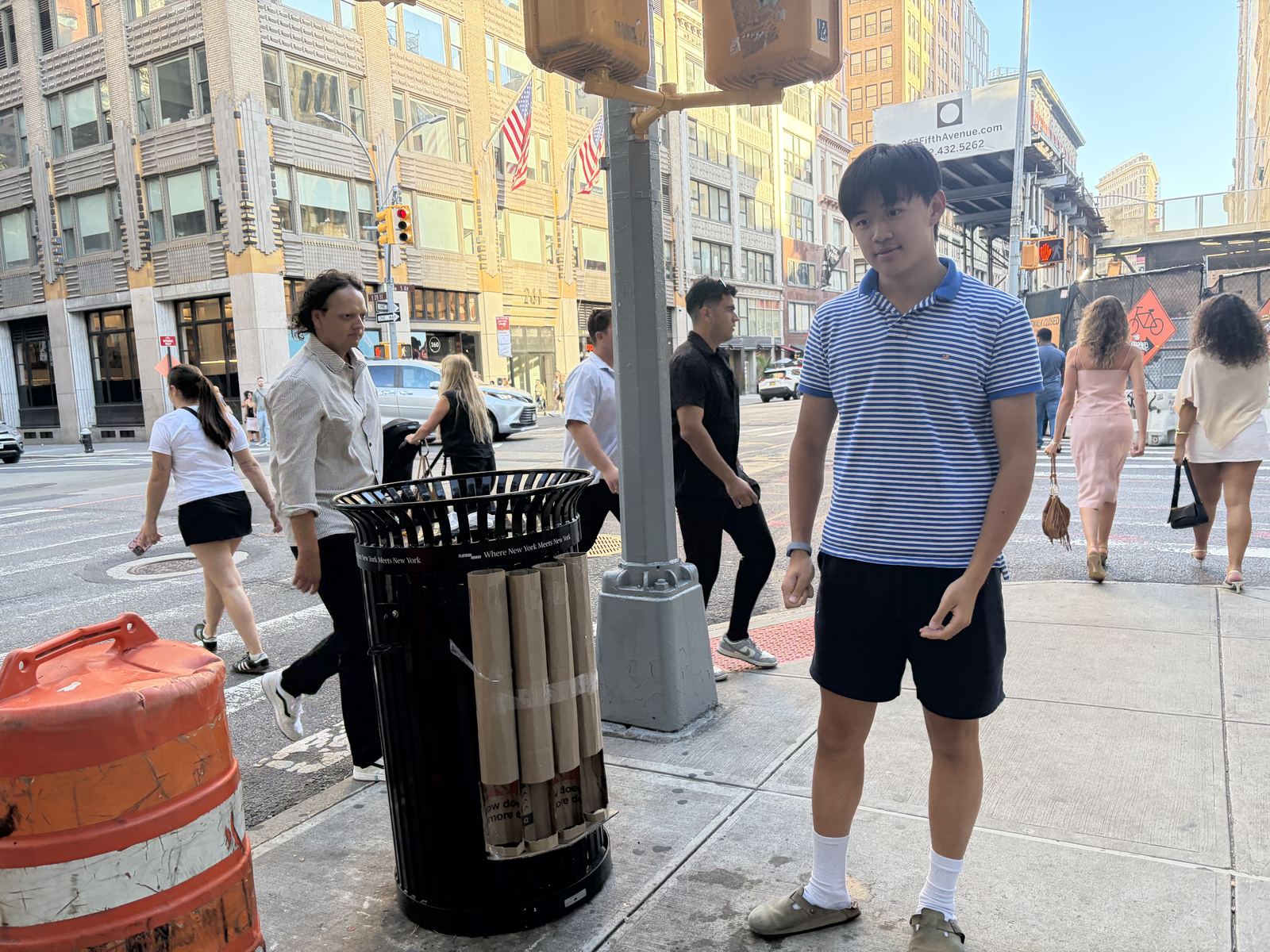 Standing beside the rack while pedestrians pass